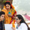 Three women looking at a paper