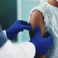 A patient getting a patch on their upper arm